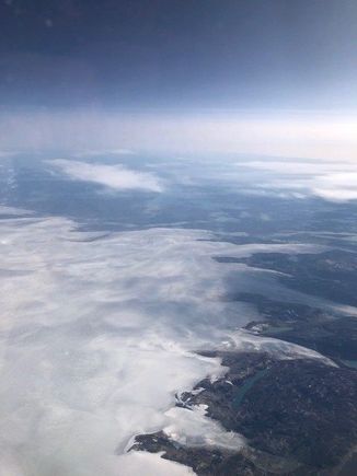 Have not flown over Greenland on a flight from Europe in quite a while. That's the ice cap not clouds in the foreground. Lots of evidence of summer melting. 