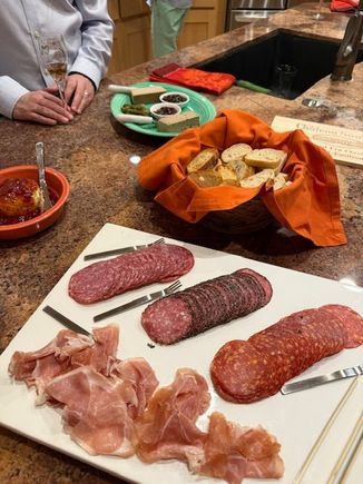 Dick liver pate with port and chicken liver and pork pate with cornichon and fig configure, various meats, Boursin with red pepper and bacon jam and more baguette slices and crostini