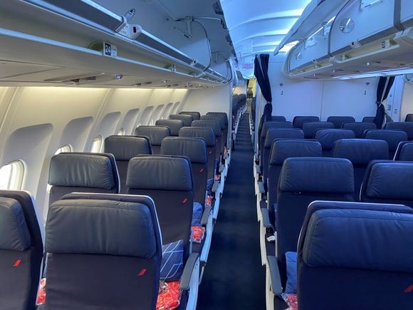 Being almost first to board, an empty economy cabin