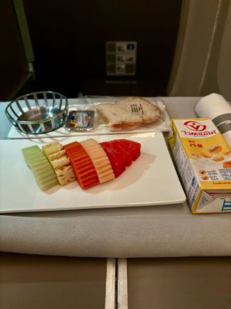 BA2230 BKK-LGW 2nd meal breakfast: fruit plate. Served with a carton of soy milk, a slice of GF bread, and the usual margarine packet.