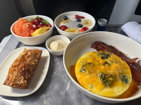 Clockwise from upper left:
Tropical Fruit Bowl (Grapefruit, Kiwi, Pineapple, Pomegranate)
Vanilla Yogurt with strawberry, blueberries, (soft) banana chips, and a dollop of the chia pudding.
Broccoli Cheddar Frittata (served with bacon, NOT the advertised tomato/bacon jam).
Carrot Pineapple Loaf with Coconut Cream Cheese spread.