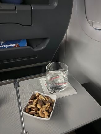 Feel like this is one of the only times my little bowl of nuts was not sad crushed pieces. Lime LaCroix to drink, had plenty of apple juice on my longer flight.