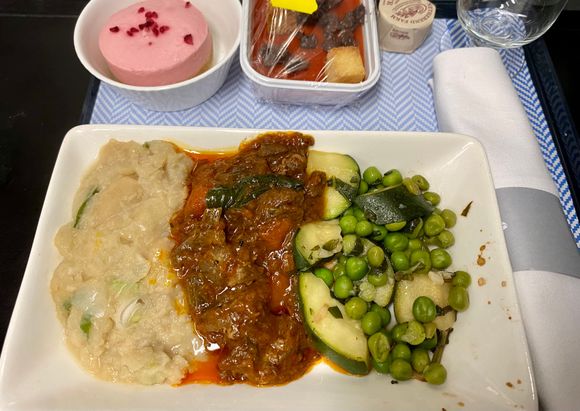 Braised neck of lamb with mint and cumin, butterbean mash, peas and courgette