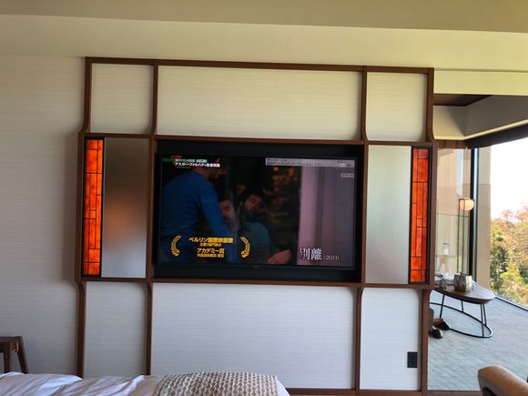 60" LCD TV with orange stained glass at each end