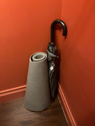 With a yoga mat and umbrella