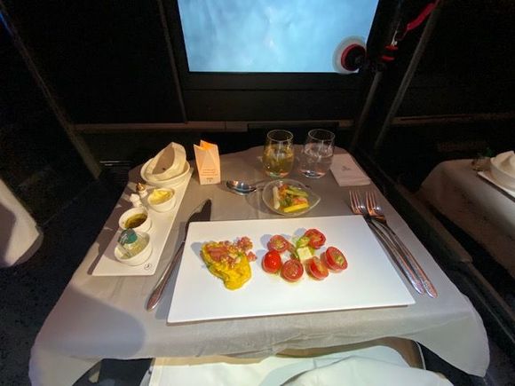 Appetizers from trolley. Shrimp was good consistency but not much flavor, like the salad and hummus. Was kind of surprised after getting multiple hits of the bread basket on the short haul flight the night before I was only ever offered one roll.