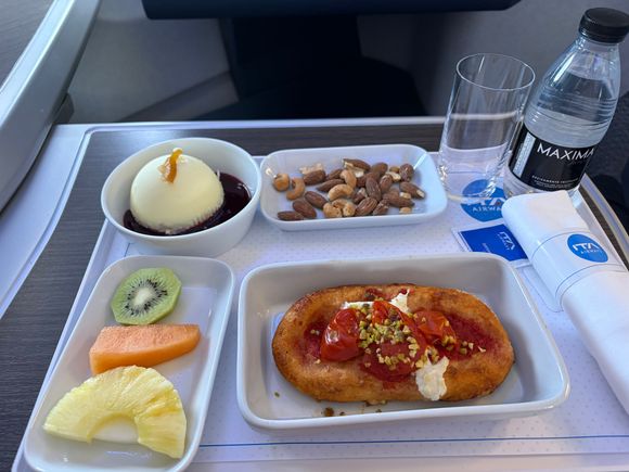 Fruit was hard an sour, pizza was weirdly soft/chewy and genuinely worse than at the gas station.
Blue packet was sugar, not salt/pepper.
Desert wasn’t for me but that’s more a me thing. Did like the nuts though. No menu, but did find a menu from a previous flight. When I checked the cheese due to allergens they did not actually verify, more vibes based.
Tried out ITA because the total trip routing included their a321neo lieflats which are great, especially row 1. That is, if the seats work.