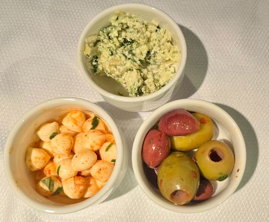 herbs and ricotta(?) spread, mozzarella balls, and olives