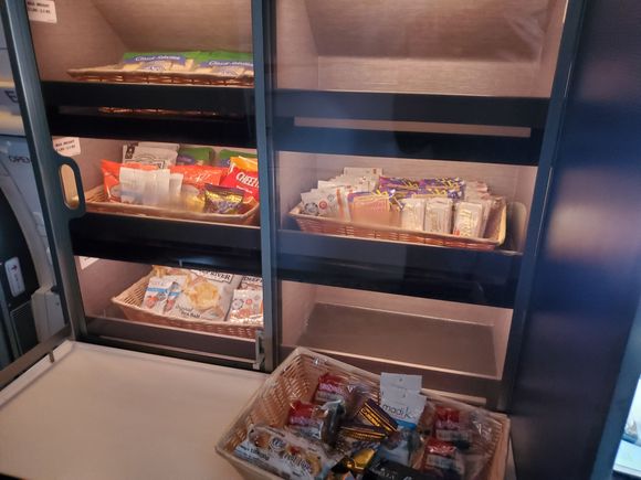 Snack counter has a basket, along with items in the cabinet for self-service, including cheese & crackers (upper left).