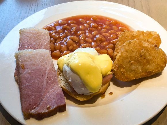 One of my breakfast plates include egg Benedict, freshly carved ham, baked beans, and hash browns.