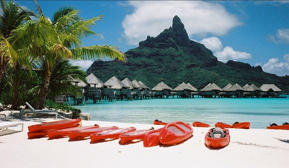 The fluorescent red kayaks strike resplendent pose against the colors of the lagoon