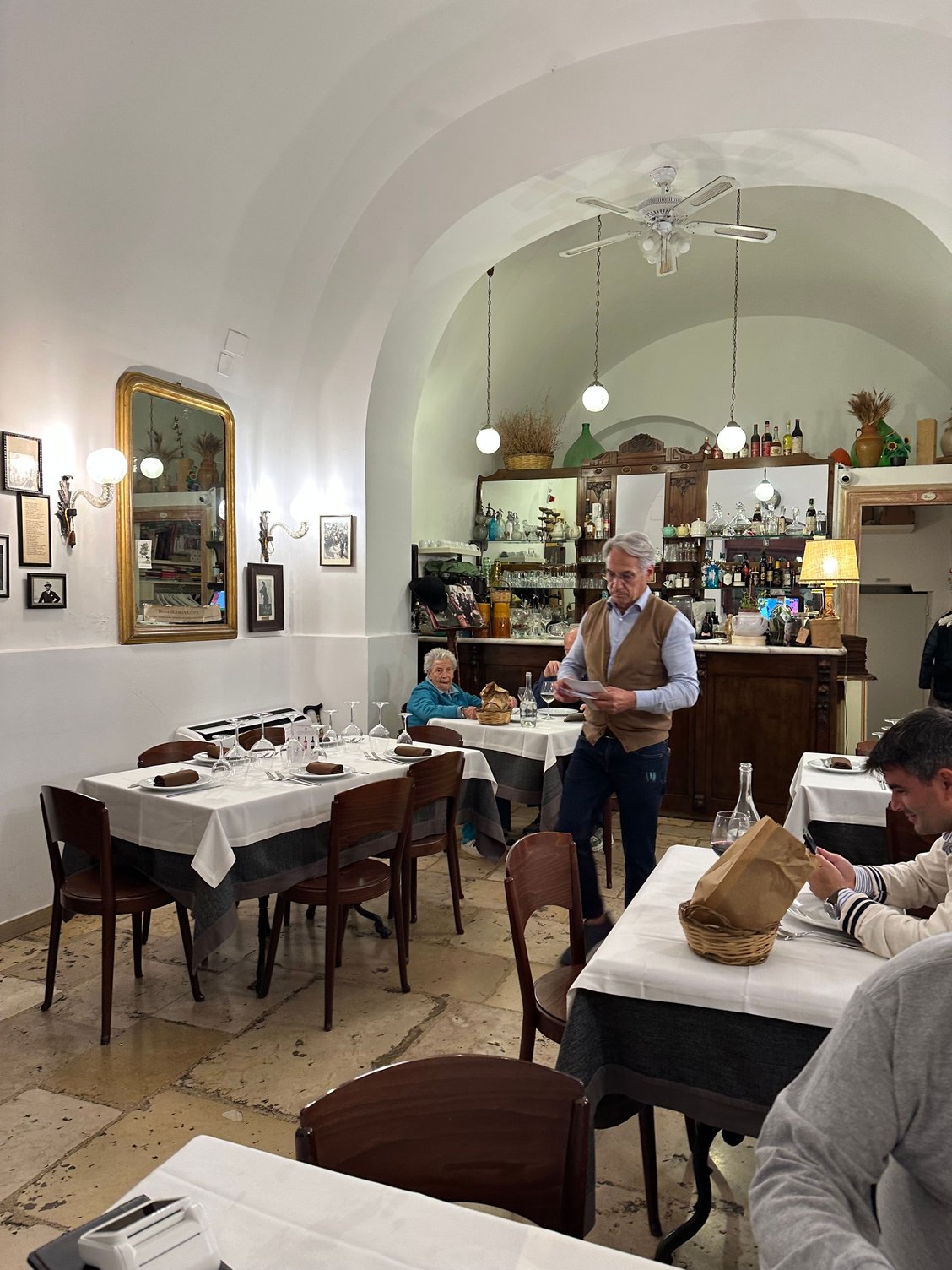 The front (of two) dining areas, with the kind owner in the center.