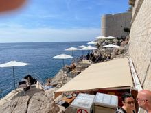 There are two "Whole in the Wall" bars Buza 1 and Buza 2.  You can go down on the rocks for a drink