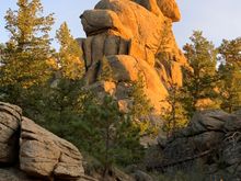 Looks like someone is carrying someone on top of the rock.