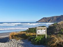 Entrance to Allans Beach on a sunny day