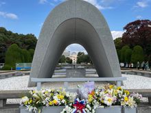 The cenotaph monument is aligned to frame the Peace Flame and the A-Bomb Dome. 