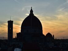 The duomo at sunset from a nearby rooftop