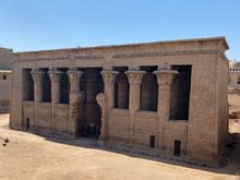 The temple sits in what appears to be a pit as the rest of the site is still buried beneath the town of Esna