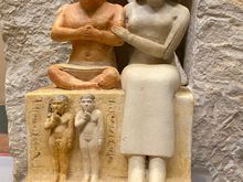 Statue of Seneb and his family. Seneb was an Egyptian with dwarfism who was a priest during the 4th dynasty and held a high position in the royal court. His wife was a priestess, and she is displayed here showing affection toward her husband in the statues