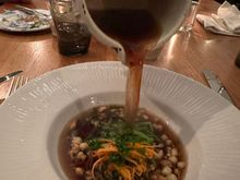 Consommé being poured into my bowl