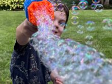 Playing with his new bubble gun!