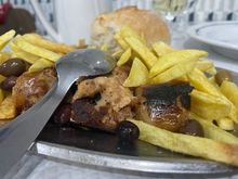 Alheira, a Portuguese sausage made with garlic and filler rather than pork - originating hundreds of years ago in the Jewish communities. 
BBC article: The Unlikely Sausage that Saved Lives
https://www.bbc.com/travel/article/20170929-the-unlikely-sausage-that-saved-lives
