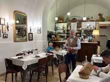 The front (of two) dining areas, with the kind owner in the center.