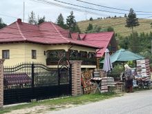 Romanian home with an elderly woman selling her goods.