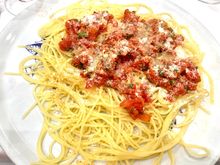 Spaghetti i topped with a fresh  tomato sauce