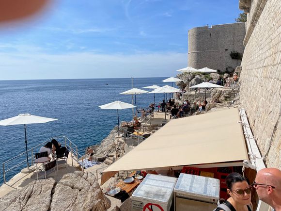 There are two "Whole in the Wall" bars Buza 1 and Buza 2.  You can go down on the rocks for a drink