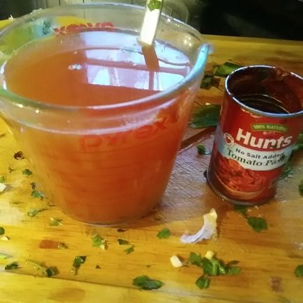 A spoon of tomato paste dissolved in warm water goes into the pot. I use no salt added paste.