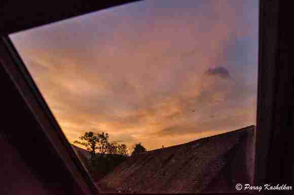 Colourful sky at the dusk over the daughters' bed, through our roof.