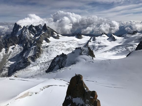 A beautiful day at Aiguille du Midi. It takes your breath away with the grandeur of the glaciers and the mountains. There were climbers returning from their glacier hikes. If you look carefully, there was a climber on top of near peak in the picture.