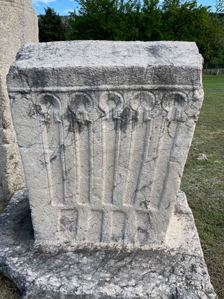 We saw a lot of this type of design and Edo said the long panels with a circle on the top represent how many children this person had. And when I say person, we are assuming it's a man.