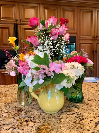Joyce and Michaela picked flowers from her gardens and put together the three vases in front. Joyce loves flowers!