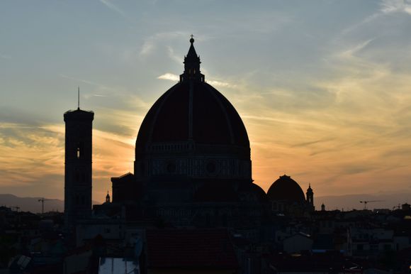 The duomo at sunset from a nearby rooftop