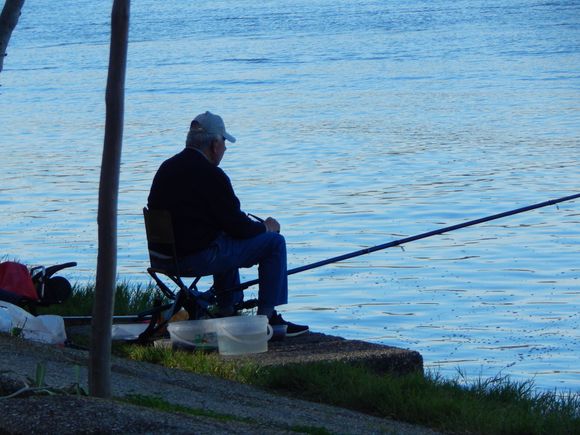 fisherman in Seville.  He was using a slingshot to send his bait into the river.