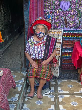 Beautiful Mayan woman outside her shop.