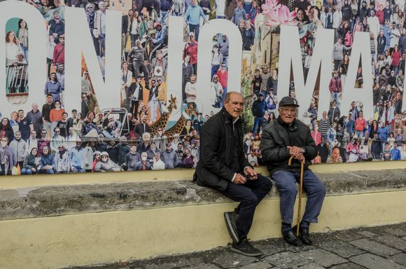 Locals pose for us by a massive mural.
