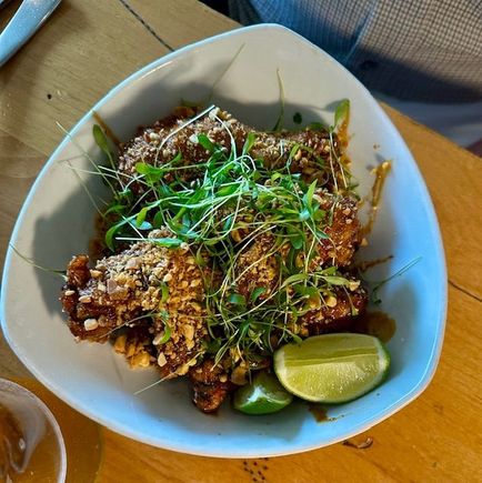 Pok Pok Bok Bok chicken, two legs, two thighs , two wings tossed in a Thai sweet and spicy glaze, garlic chips, crushed peanuts and fresh lime.  This one was crispy, hot and utterly delicious.