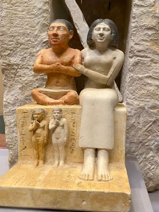 Statue of Seneb and his family. Seneb was an Egyptian with dwarfism who was a priest during the 4th dynasty and held a high position in the royal court. His wife was a priestess, and she is displayed here showing affection toward her husband in the statues