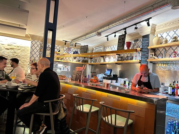 Seating available along the bar, as well as at high top tables.