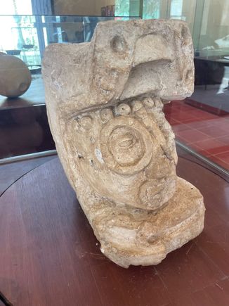 This was found at Ek-Balam.  It is a man, head, coming out of a serpent's mouth.  It's a Mayan myth that man was born out to the snake, or maybe the snake was eating us and thought we tasted like chicken?  Not sure.