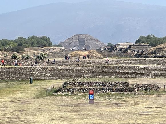 Avenue of the Dead.  Other groups, not the original inhabitants used this roadway to bury people.  The mound you see right behind the red sign is some kind of crypt.