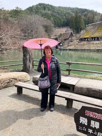 Hida Folk Village - lake and buildings beyond (parasols were available and I couldn't resist the pink!)