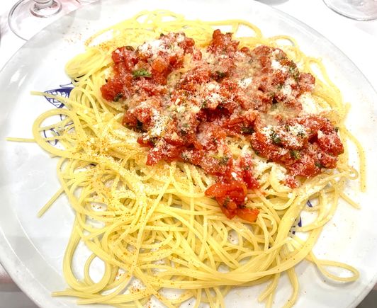 Spaghetti i topped with a fresh  tomato sauce
