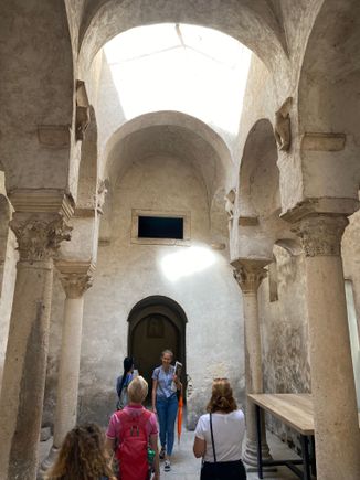 Cafe with ruins of medieval chapel in the back