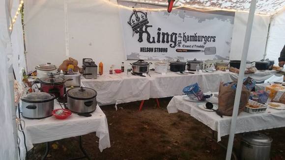 Here's my photo attempt. This is the cook tent the guys set up when they do their private camping weekend. They have to use generators to run the crockpots. In addition to the graphic banner, they design and order sweatshirts and tees each year. The graphic is derived from the famous King of the Hammers race logo. I think they got permission to modify it for their use. 