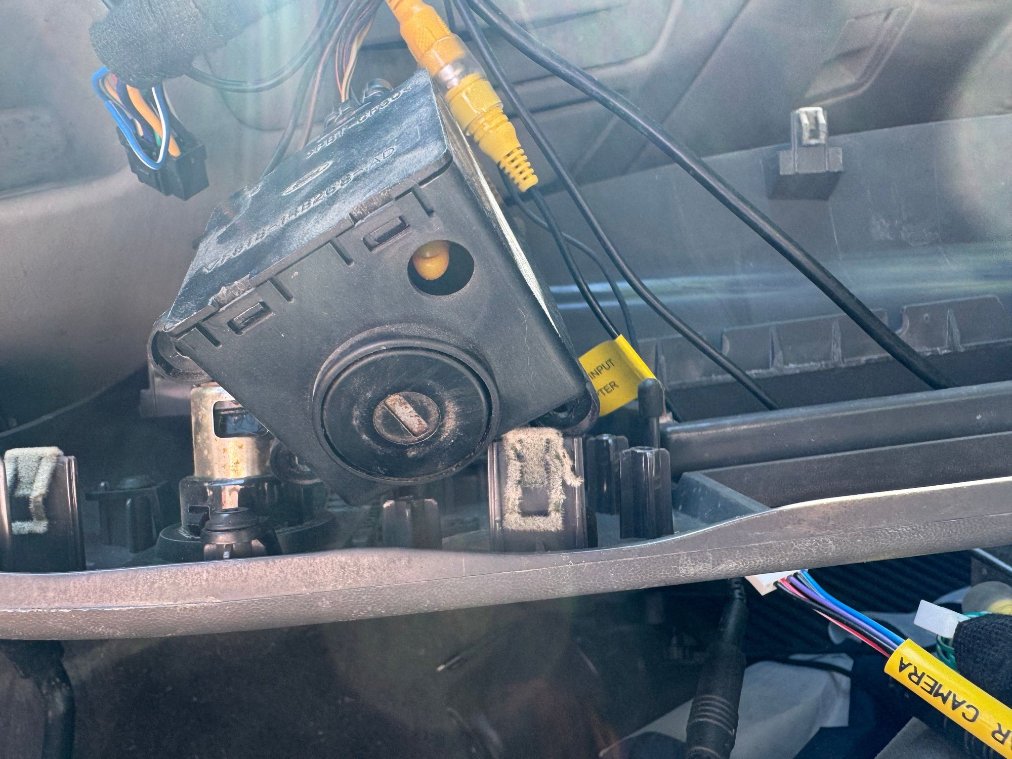 You use a small flat head screwdriver to carefully pop up the tabs and lift a cover (seen on the top in this view) on one side of the box to access the PCB.