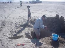 Father and son bonding in the sand. Think this is where Sean was building a really deep moat.